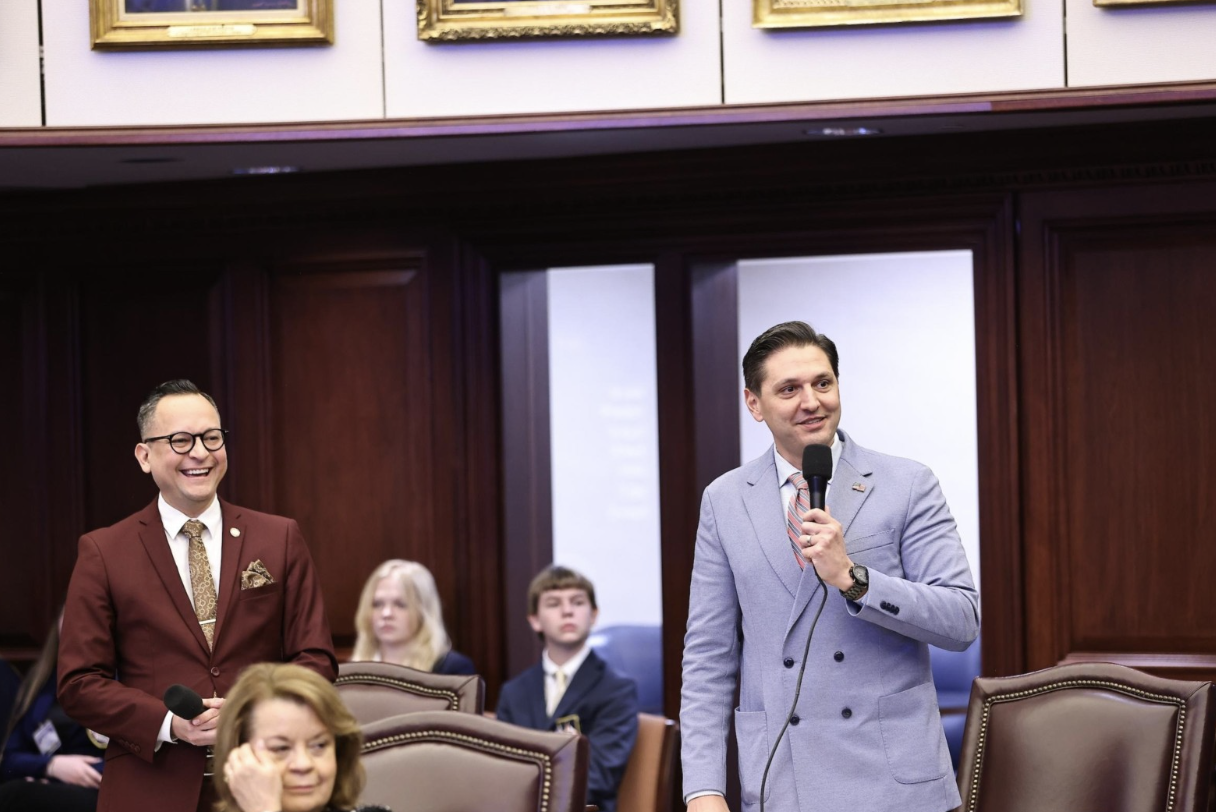 Sen. Carlos Guillermo Smith, a Democrat, celebrates with Sen. Danny Burgess, a Republican as their bill advances