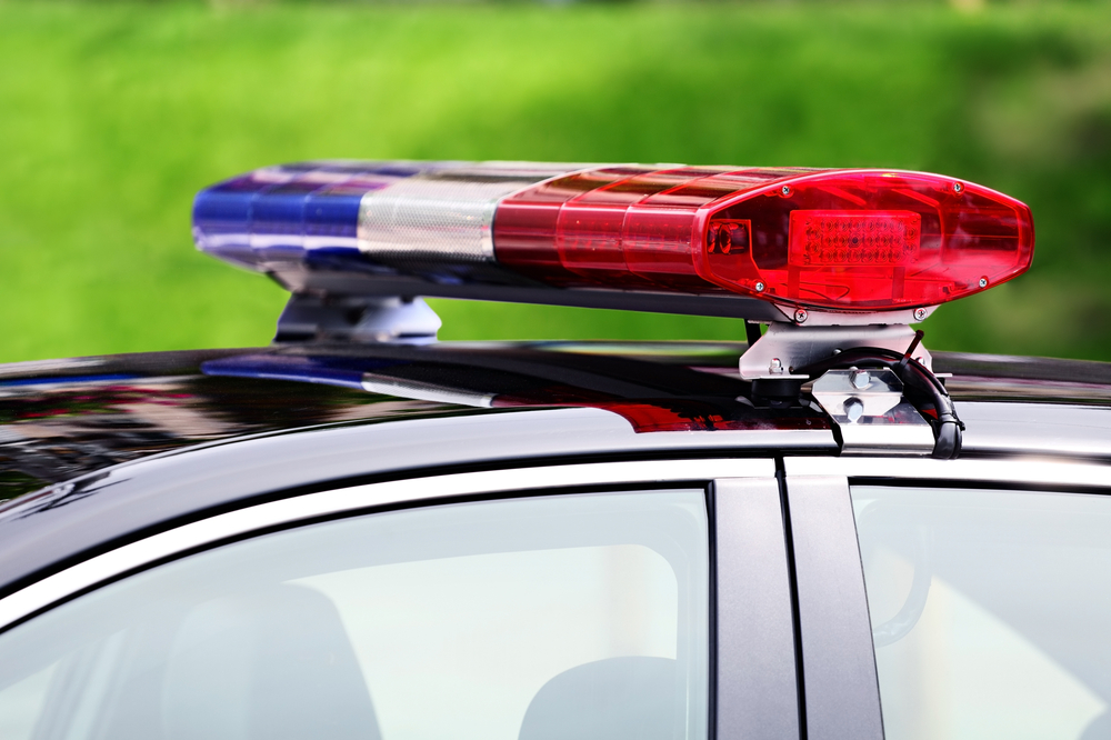 Police,Car,With,Siren,Light,Closeup,On,Green,Background,,Selective