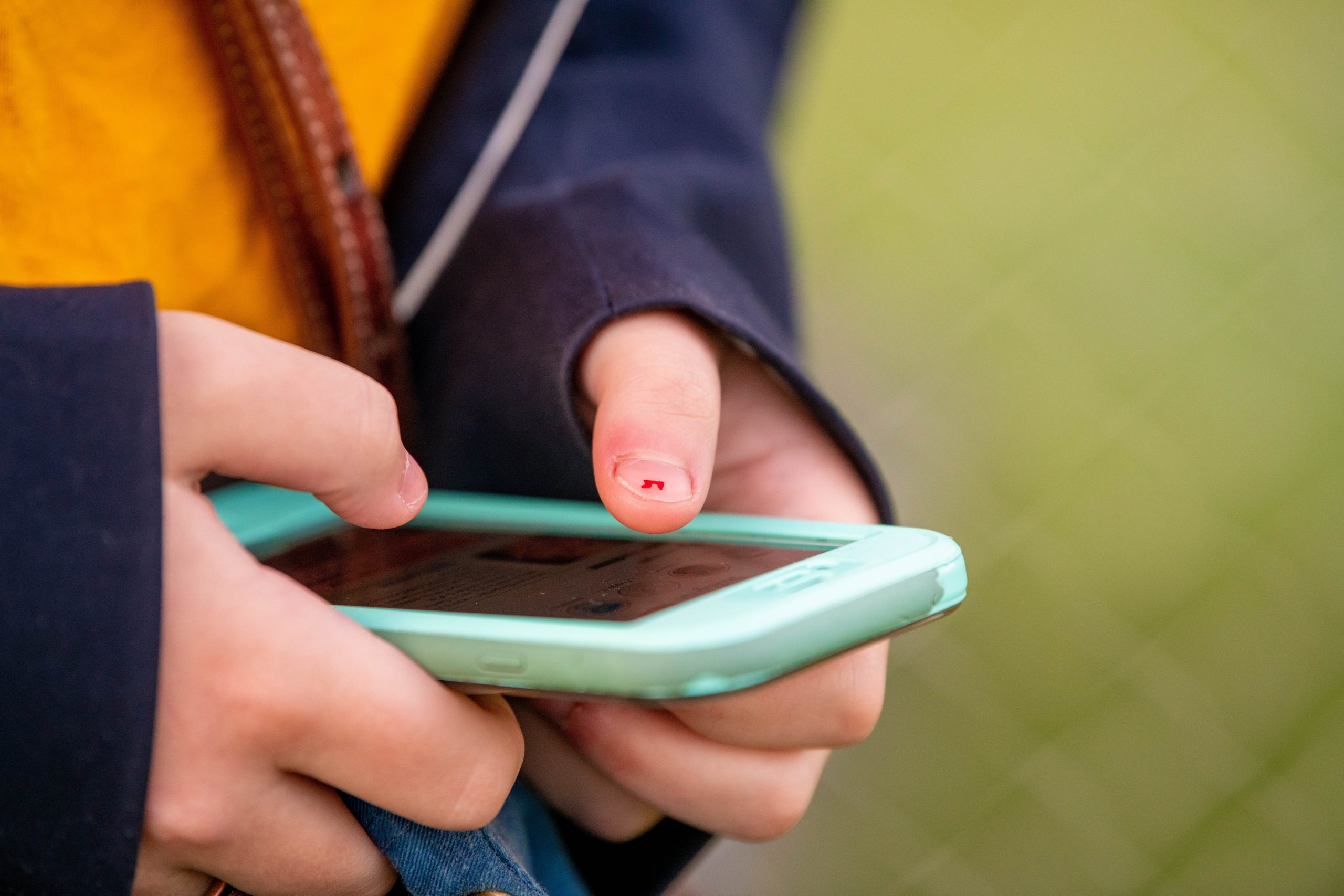 A,Teenager,Types,On,A,Cellphone.,The,Teenager,Has,Chipped