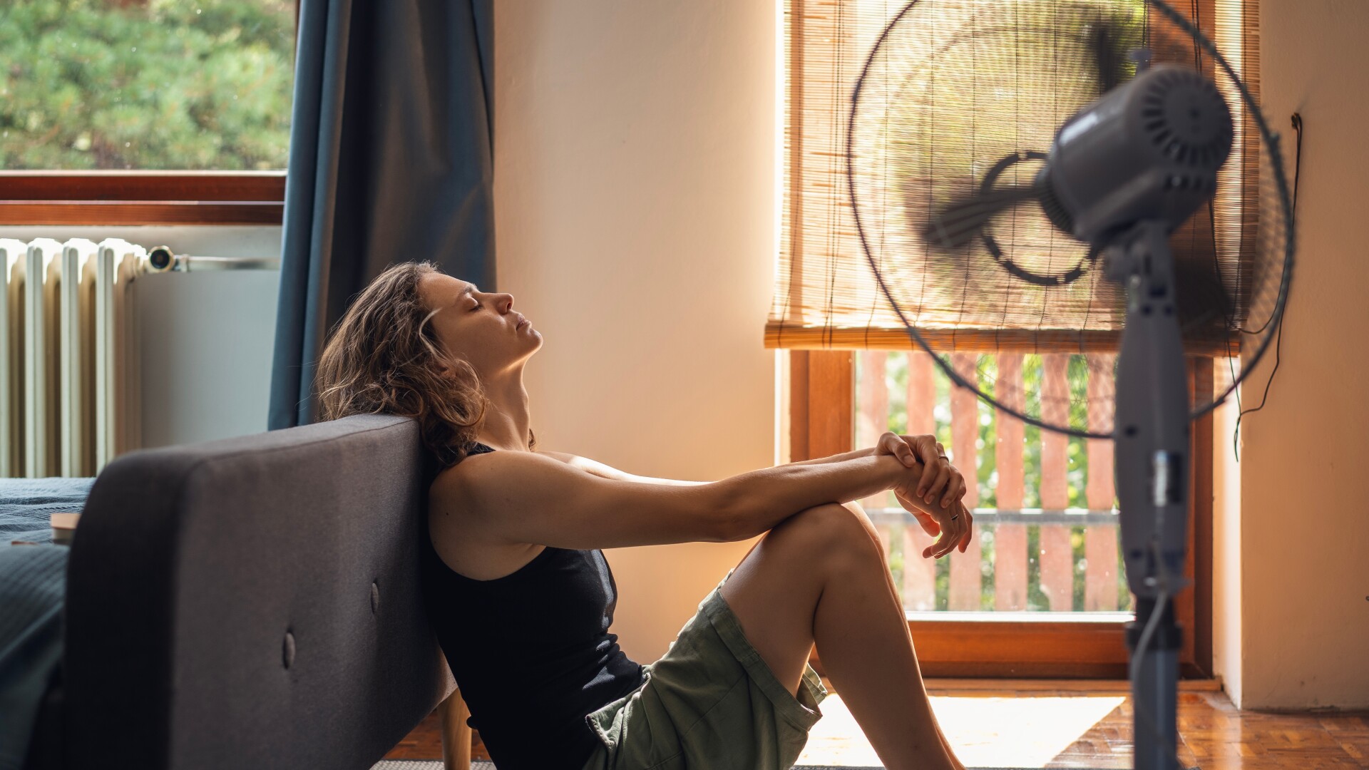 Woman suffering from extreme heat in her home.