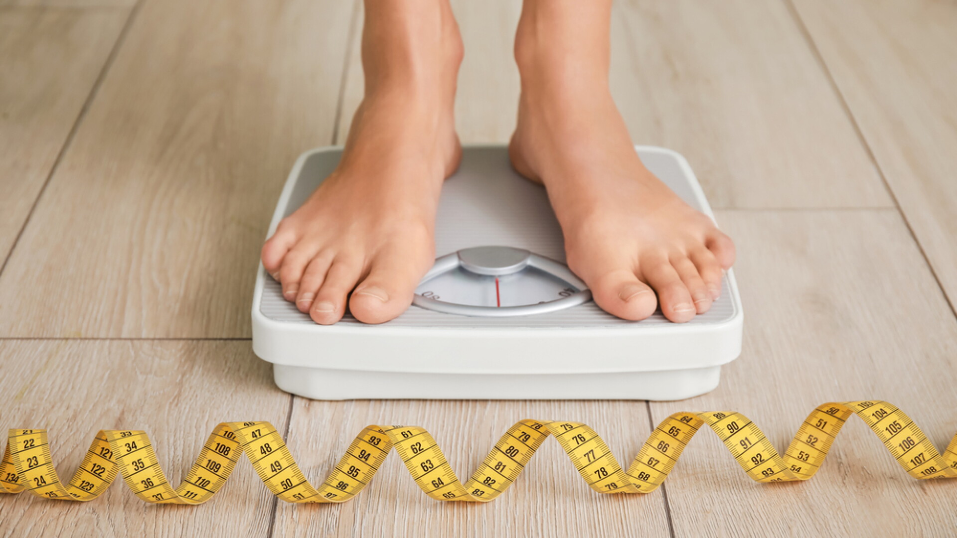 Young,Woman,Measuring,Her,Weight,At,Home